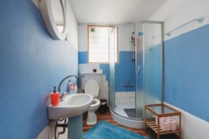 A corner shower installation in a small bathroom