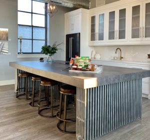 A large kitchen island in a cook's dream kitchen